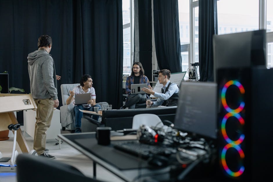 A group of professionals engaged in a casual meeting at a modern office.